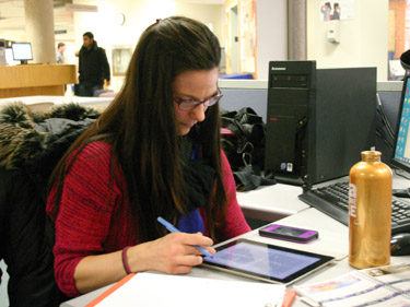 Student reads an iPad