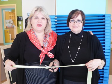 Kids and Company CEO Victoria Sopik (left) stands beside vice-president of operations Sue Purser (right) for the ribbon cutting in celebration of their grand opening.