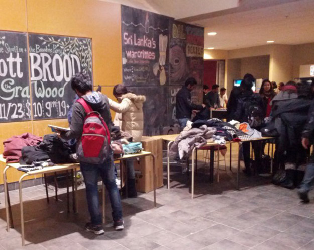 Students browse through the donated winter coats at the Student Union Building. (Photo: Mackenzie Scrimshaw)