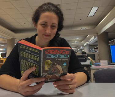 Corinne Gilroy, an employee at the library, finds it strange the stories are not as sexual at the covers suggest. (Photo: Tyler LeBlanc)