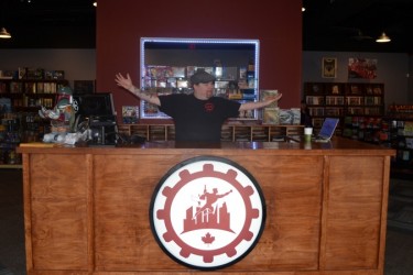 Patrick McMerty poses at the front desk of Quantum Frontier.