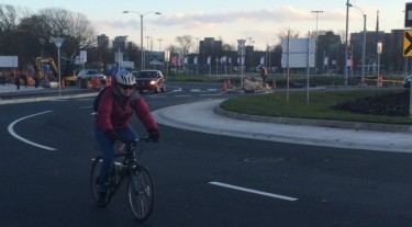 Cyclist on North Park roundabout one day after it is completed.
