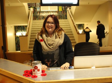 Cassandra Duffenais distributes poppies from the desk in the Dal Student Union Building. Photo: Hanna McLean