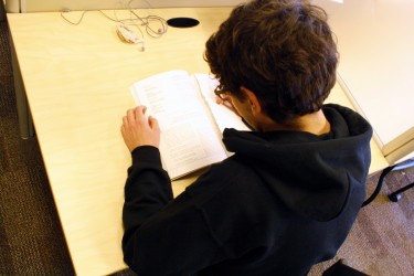 A SMU student studying in the library.