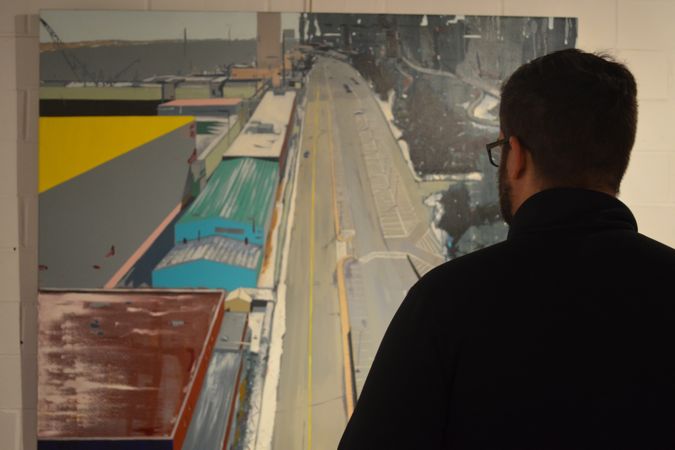 A man looks at a painting