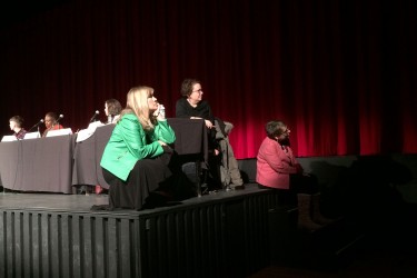 Three panelists at Dal's forum on misogyny watch a rap video at the beginning of the discussion. Photo: Keili Bartlett