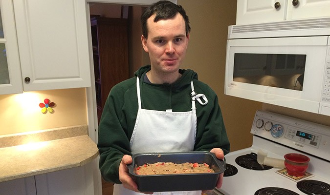 Iain Downey prepares to put his strawberry chocolate chip bread in the oven. Photo: Nikki Sacuta